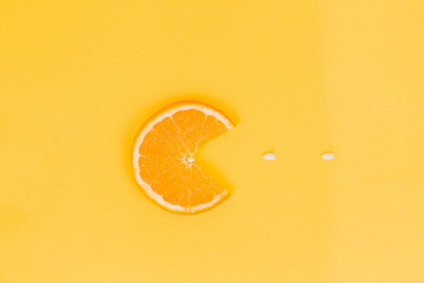 Orange slice with seeds on orange background