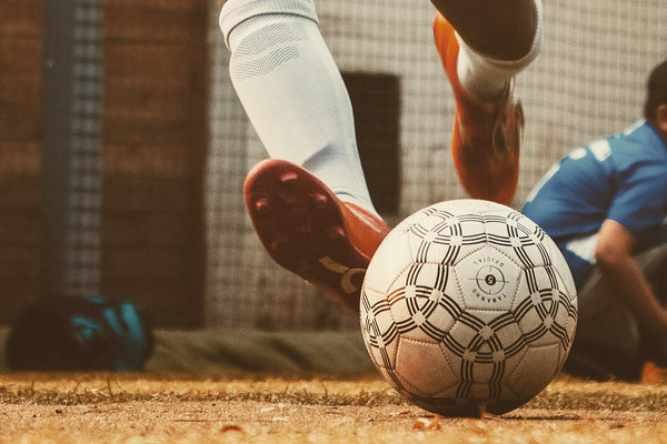 soccer ball being kicked by athlete