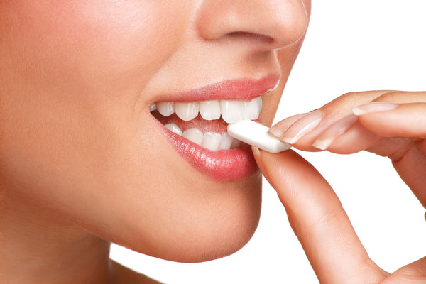 Closeup of a woman taking CBD Mints for oral hygiene and wellness 