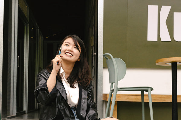 woman in split frame left holding a vape pen and Infused Amphora cbd vape cart MEND. Right screen desk and chair setup