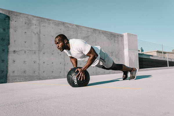 Man doing crunches with medicine ball after cbd
