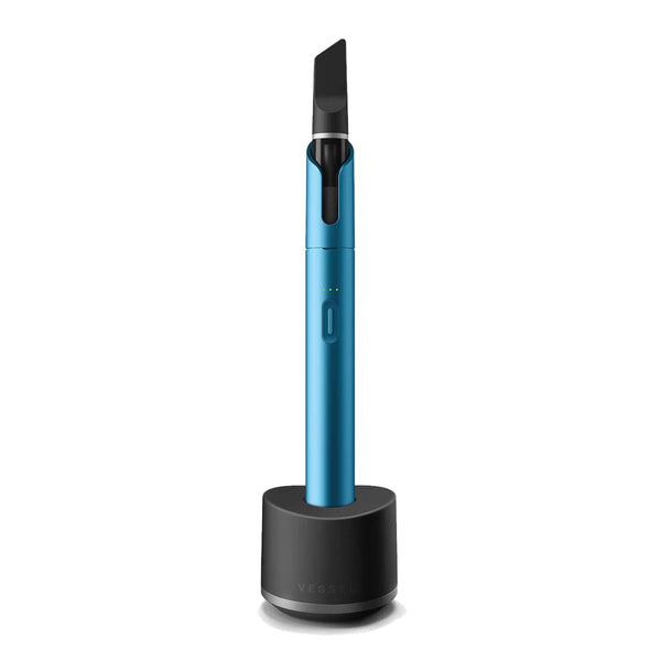 Electric Blue Vista Vape Pen with CBD Vape Cartridge, connected to a Base Charging Stand